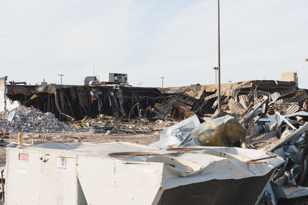 Debris scattered in front of a building, indicating recent demolition work by a junk removal service in San Antonio, TX.