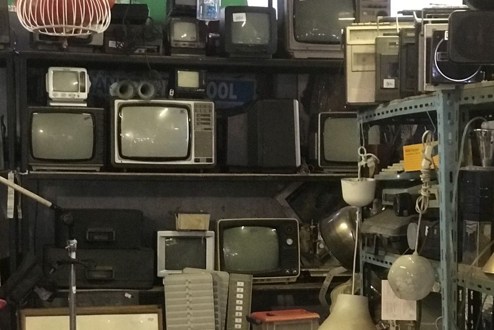 A room packed with outdated televisions and electronics, representing e-waste for a junk removal service in San Antonio, TX.